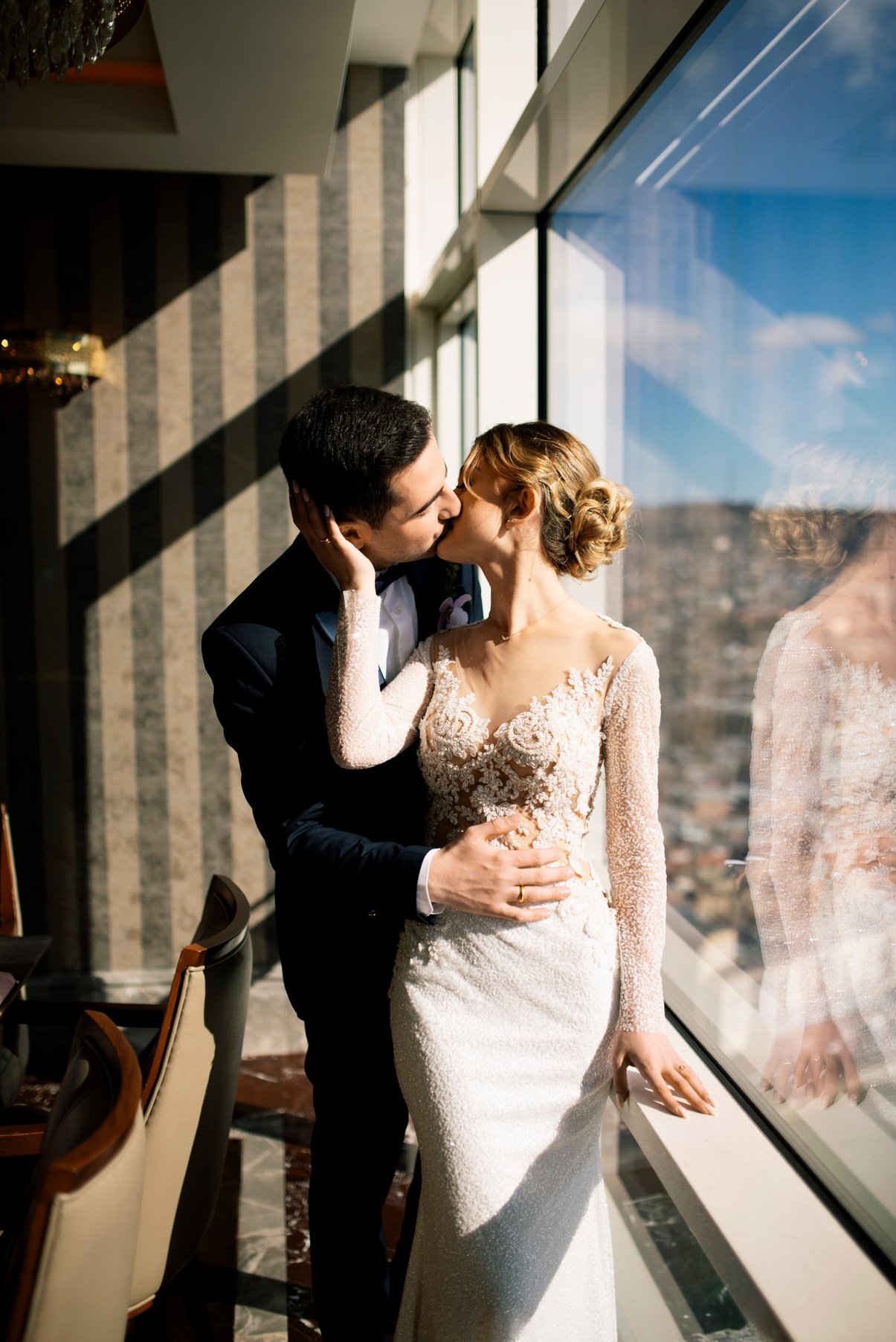 Man in Black Suit Kissing Woman in White Dress